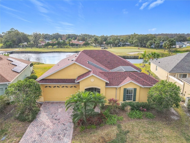 view of front of house featuring a garage and a water view