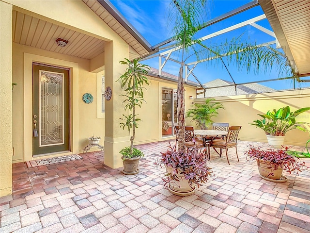 view of patio / terrace featuring glass enclosure