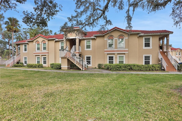 mediterranean / spanish-style home with a front lawn