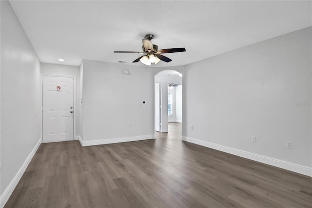 spare room featuring dark hardwood / wood-style floors and ceiling fan