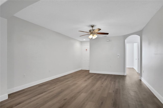 spare room with ceiling fan and dark hardwood / wood-style flooring