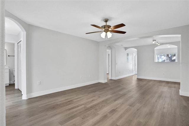 unfurnished living room with ceiling fan and hardwood / wood-style floors