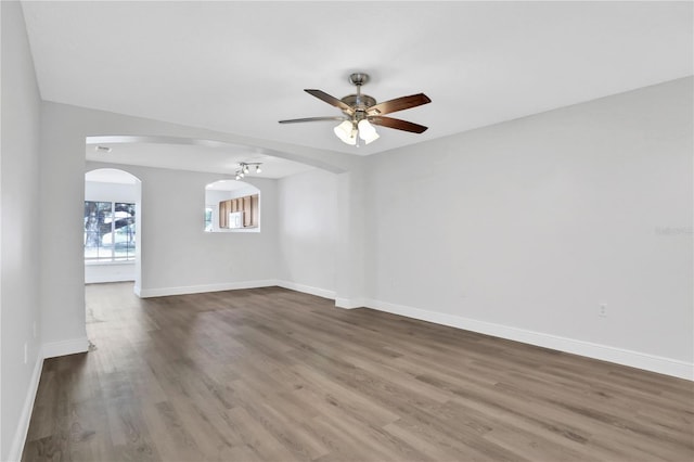 empty room with hardwood / wood-style flooring and ceiling fan