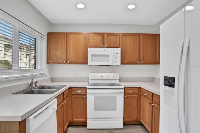 kitchen featuring white appliances and sink