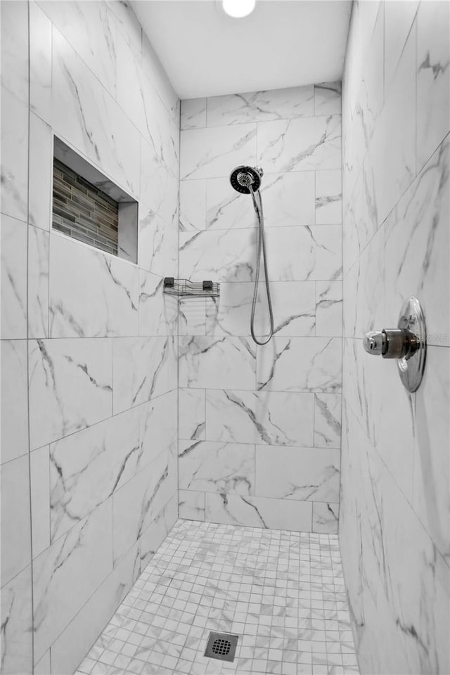 bathroom with tiled shower