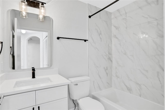 full bathroom with vanity, tiled shower / bath combo, and toilet