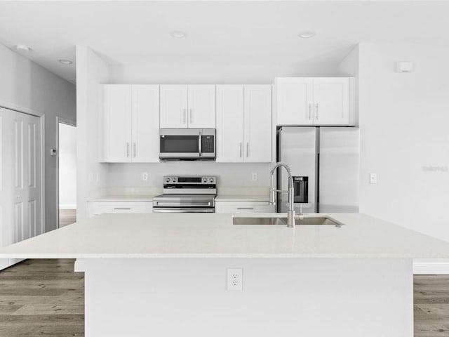 kitchen with white cabinetry, sink, stainless steel appliances, and light wood-type flooring