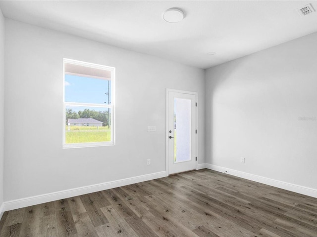 spare room with dark wood-type flooring