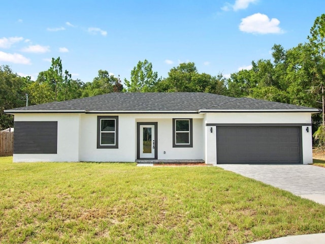 single story home with a garage and a front yard