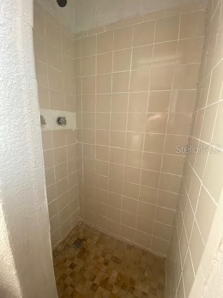 bathroom with tiled shower