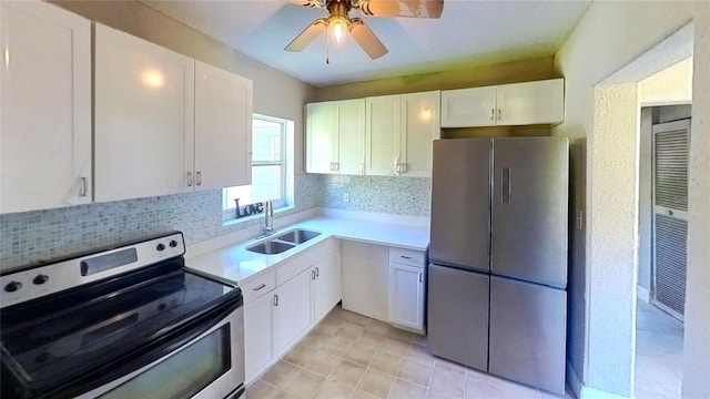 kitchen featuring appliances with stainless steel finishes, white cabinets, and a sink