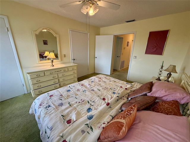 bedroom with carpet, ceiling fan, and a textured ceiling