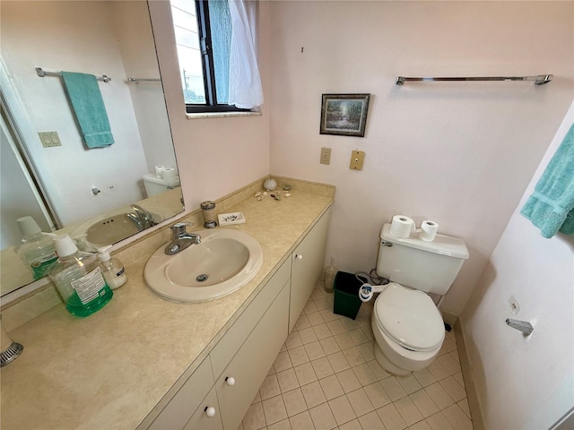 bathroom featuring tile patterned floors, vanity, and toilet