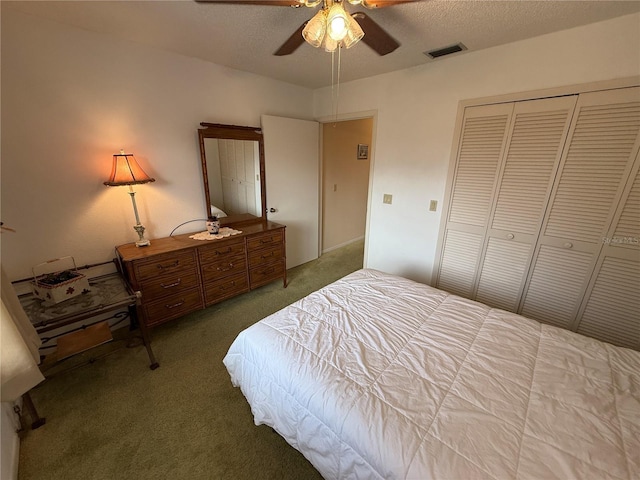 carpeted bedroom featuring a textured ceiling, a closet, and ceiling fan