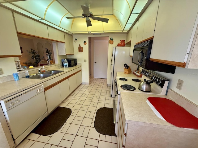 kitchen with white cabinetry, ceiling fan, sink, white appliances, and light tile patterned floors