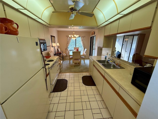 kitchen featuring ceiling fan with notable chandelier, white appliances, sink, light tile patterned floors, and hanging light fixtures