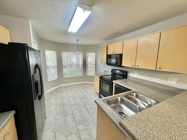 kitchen featuring pendant lighting, sink, black appliances, light brown cabinets, and a textured ceiling