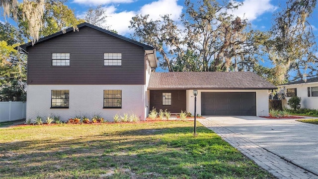 view of front of house with a garage and a front lawn