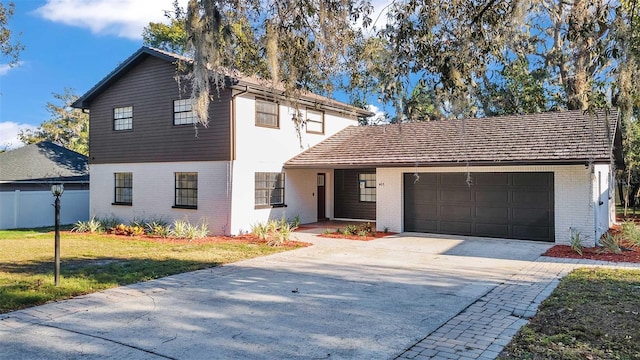 view of front of property with a front lawn and a garage