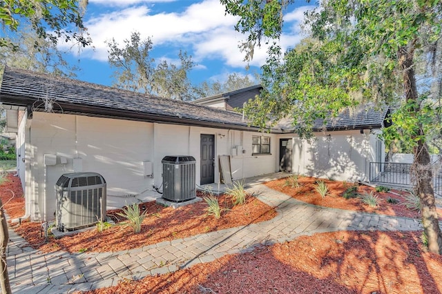 rear view of property featuring central AC