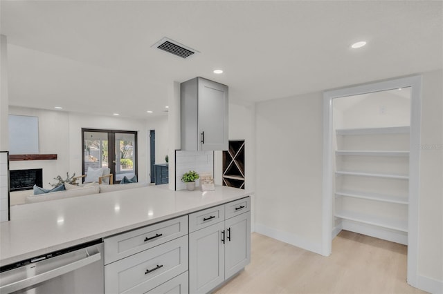 kitchen with dishwasher, light hardwood / wood-style floors, decorative backsplash, and french doors