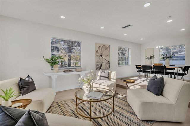 living room featuring light hardwood / wood-style flooring and a notable chandelier