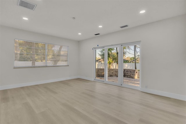 unfurnished room with light hardwood / wood-style floors