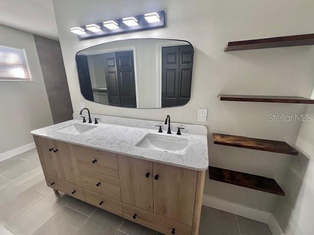 bathroom with tile patterned flooring and vanity