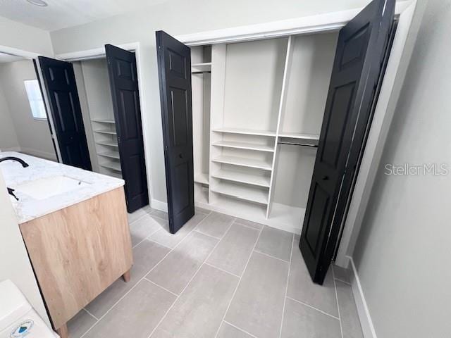 interior space with sink and light tile patterned flooring