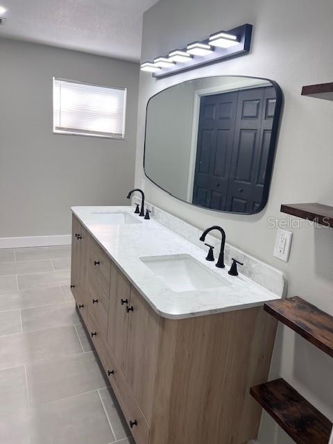 bathroom with vanity and tile patterned floors