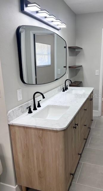 bathroom featuring tile patterned flooring and vanity