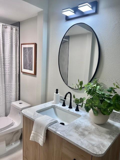 bathroom featuring vanity and toilet