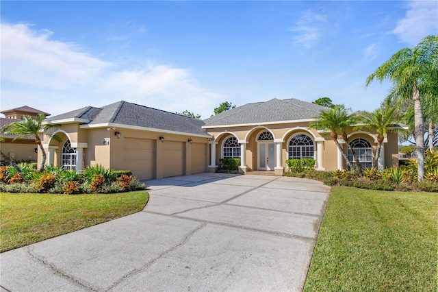 view of front of house featuring a garage and a front lawn