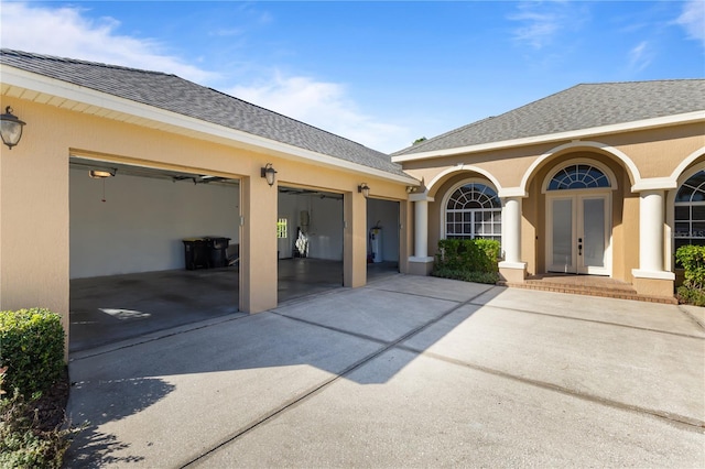 view of patio featuring french doors and a garage