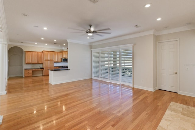 unfurnished living room featuring ceiling fan, light wood-type flooring, and crown molding