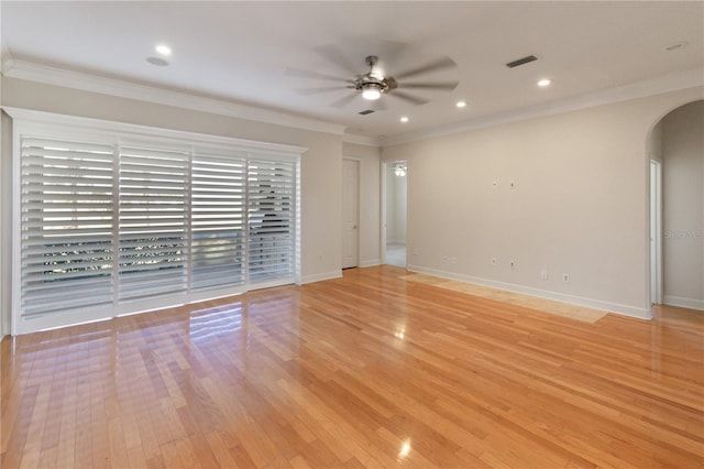 spare room with ceiling fan, light wood-type flooring, and ornamental molding