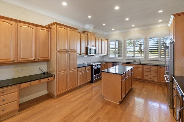 kitchen featuring a center island, stainless steel appliances, crown molding, and sink