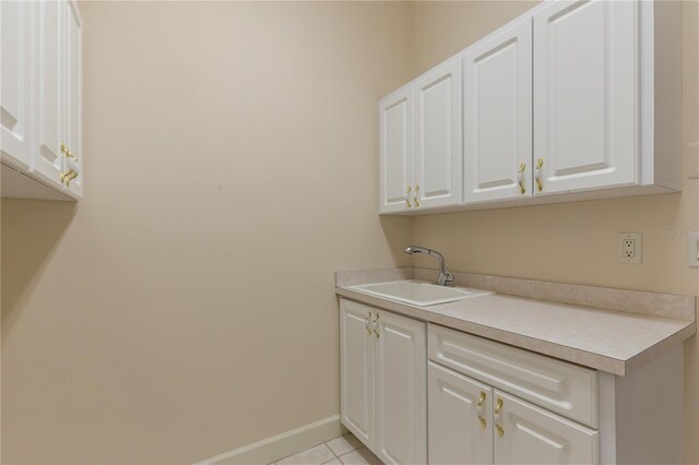 laundry room with light tile patterned floors and sink