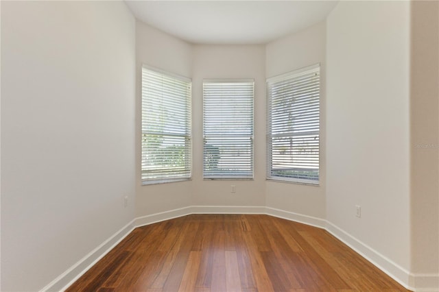 unfurnished room with hardwood / wood-style floors