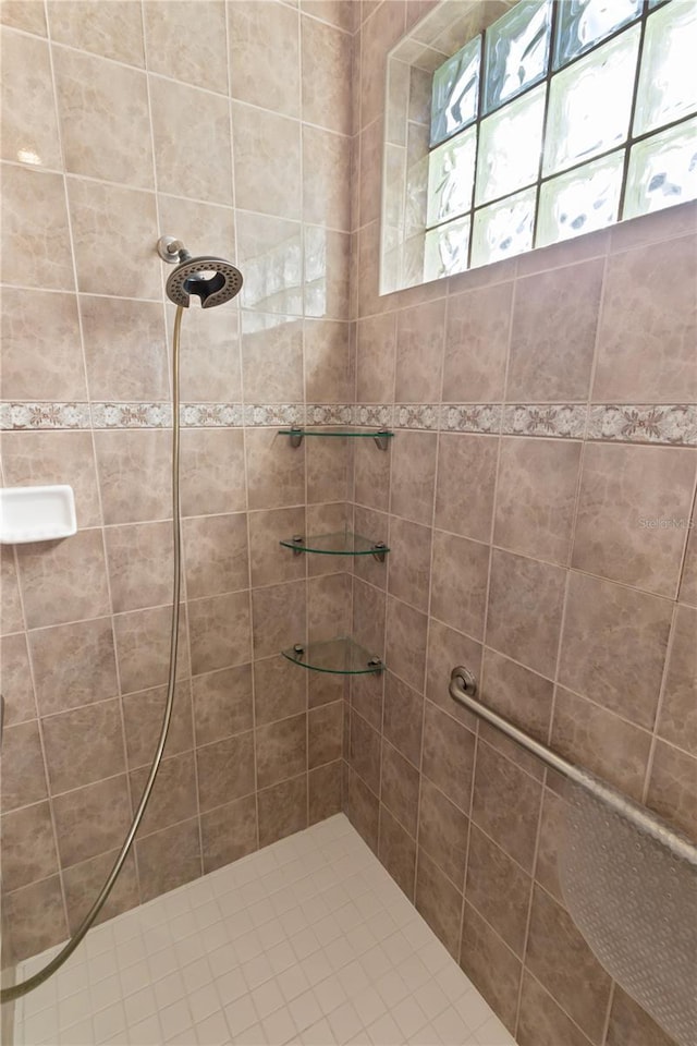 bathroom with tiled shower