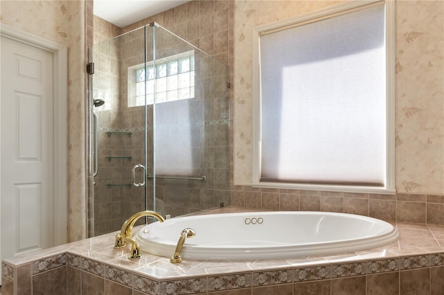 bathroom featuring shower with separate bathtub