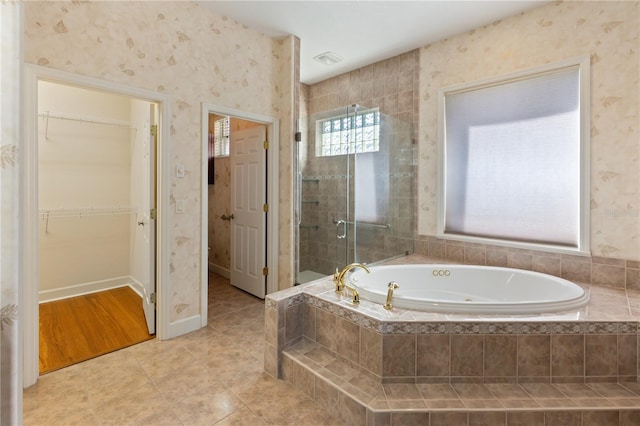 bathroom featuring tile patterned flooring and independent shower and bath