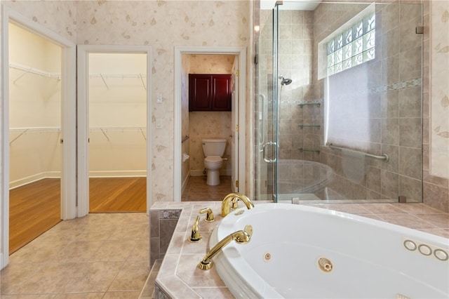 bathroom featuring tile patterned flooring, separate shower and tub, and toilet