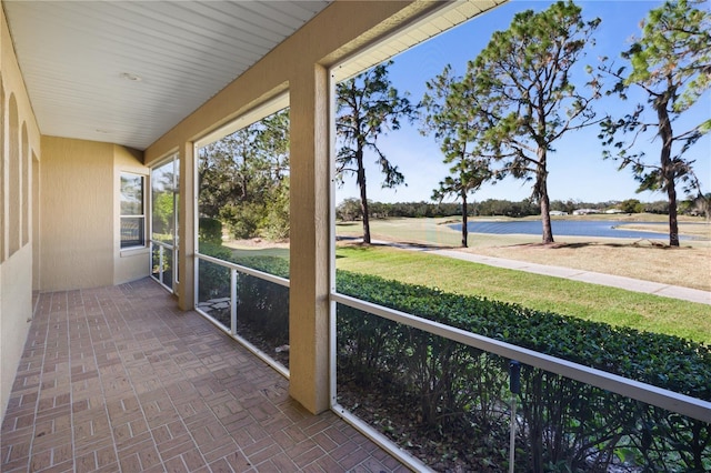 unfurnished sunroom with a water view