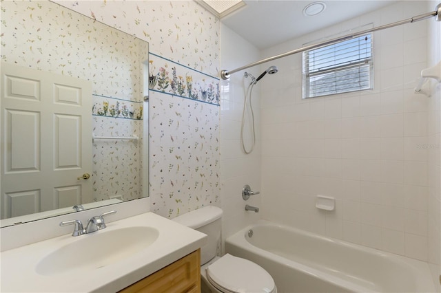 full bathroom with toilet, vanity, and tiled shower / bath