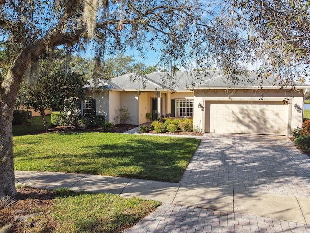 single story home with a garage and a front lawn