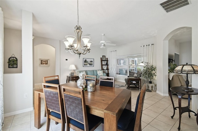 dining room featuring light tile patterned floors and ceiling fan with notable chandelier