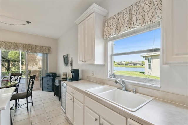 kitchen with a water view and white cabinetry