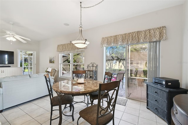 dining space with ceiling fan and light tile patterned floors