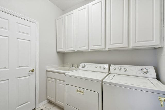 clothes washing area with cabinets, independent washer and dryer, light tile patterned floors, and sink